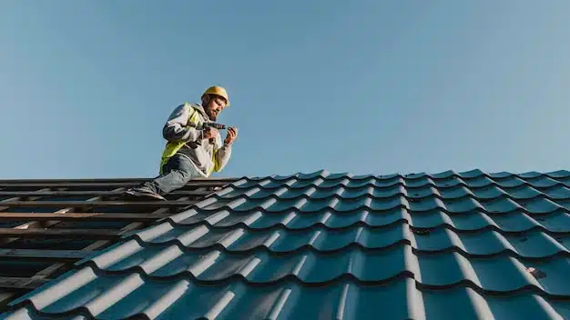 homme en haut d'un toit vu d'en bas
